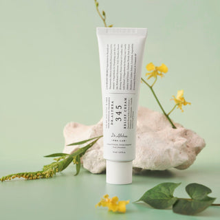 Tube of skincare product with natural elements on a light green background